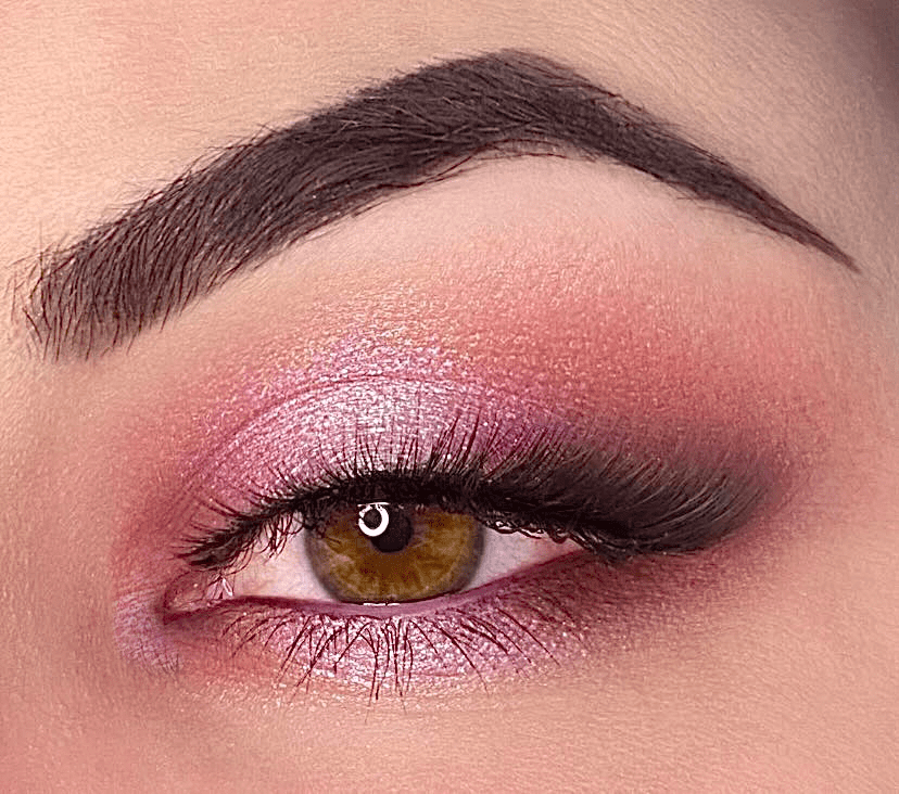Woman with light skin wearing eyeshadow in pink and pinky brown neutral metallic and matte shades.