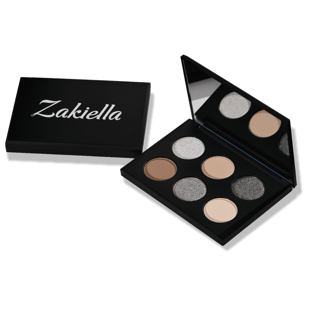 Serenity Eyeshadow Palette shown open with a closed one beside it showing the Zakiella logo. The eyeshadows are a mix of metallic and matte shades of cool brown neutrals.